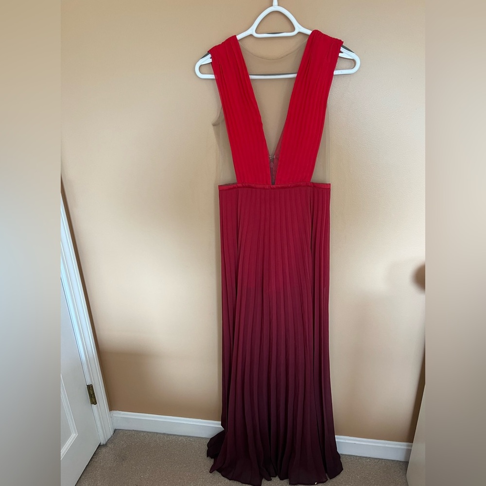 Size 6 red Bebe gown. Sheer bottom but has built in thin red shorts.